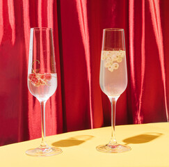 Two cocktails with red and white current. Stylish velvet magenta texture background and warm yellow bottom.