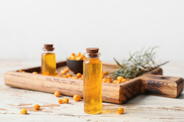 Bottle of sea buckthorn essential oil on table