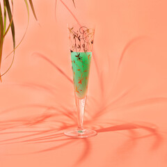 Obraz premium A unique glass with cocktail summer shade warm terracotta background. Afterparty chill vibe around.