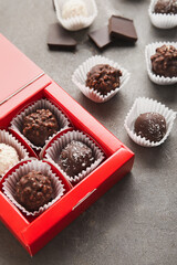 Box with sweet chocolate candies on grunge background