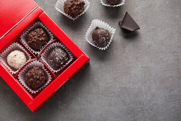 Box with sweet chocolate candies on grunge background