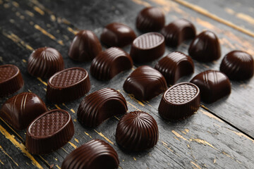 Sweet chocolate candies on dark wooden background