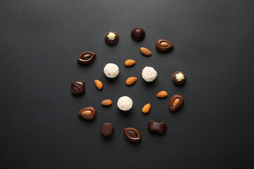 Sweet chocolate candies with nuts on dark background