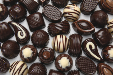Sweet chocolate candies on light background