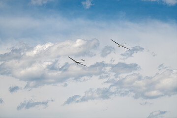 the plane is towing the glider across the blue sky