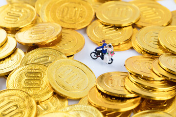Groom bikes with bride among gold coins
