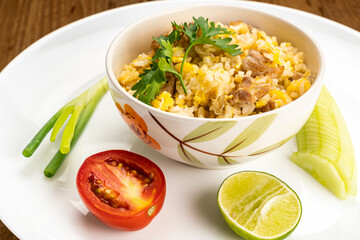View of thai style delicious homemade fried rice with pork, egg, garlic and pepper in ceramic bowl.