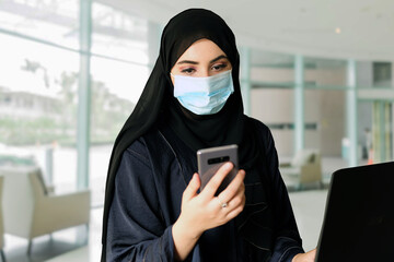 Emirati woman wearing facemask to protect from COVID19 pandemic ideal for health care concept. Arab...