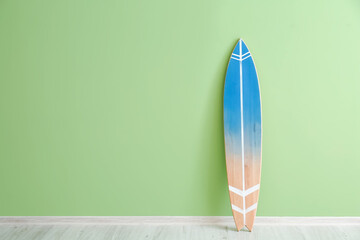 Blue surfboard near color wall