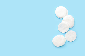 Cotton pads on color background