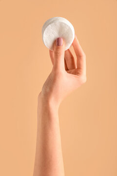 Female Hand With Cotton Pads On Color Background