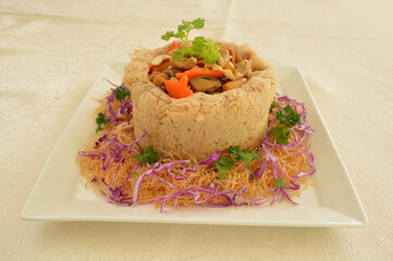 deep fried crispy yam taro ring with stir fried mixed seafood and meat nut in chef oyster sauce asian halal menu