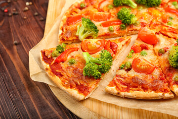 Board with tasty vegetarian pizza on wooden background, closeup