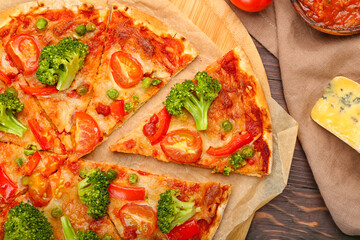 Board with tasty vegetarian pizza on wooden background