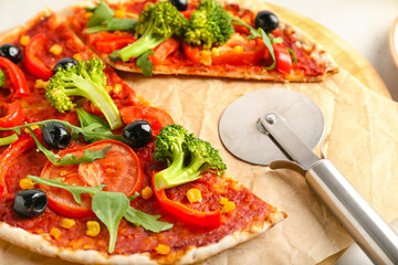 Board with tasty vegetarian pizza on table, closeup