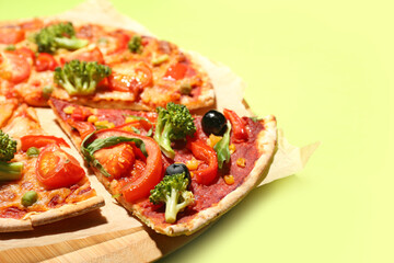 Board with tasty vegetarian pizza on color background, closeup