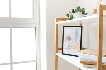 Book shelf with picture near window