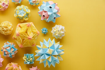 Set of multicolor handmade modular origami balls or Kusudama Isolated on yellow background. Visual...