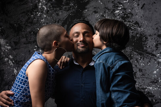 Happy Multiracial Family On Dark Background In Studio