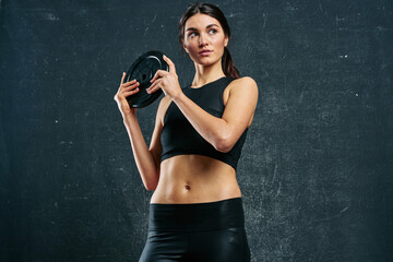 Fototapeta na wymiar sports woman slim figure workout dark background