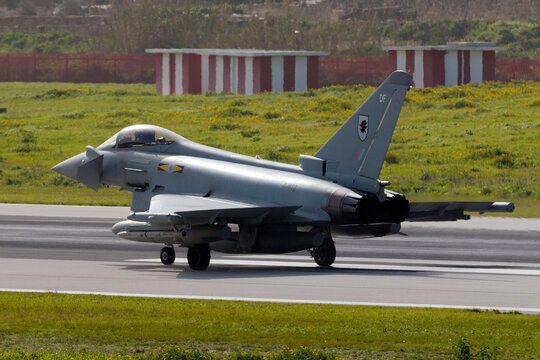Luqa, Malta February 5, 2015: Royal Air Force Eurofighter EF-2000 Typhoon FGR4 (ZJ933) backtracking for take off from runway 31 accompanied by another 3 Typhoons and a Voyager tanker aircraft.