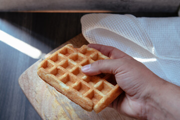 Close-up of a hand taking a artisan waffle