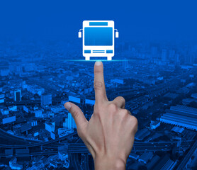 Hand pressing bus flat icon over modern city tower, street, expressway and skyscraper, Business...