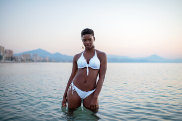 Black woman with short hair in the sea