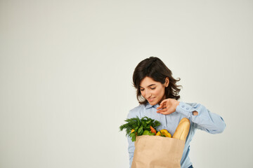 pretty brunette in blue shirt grocery bag organic food