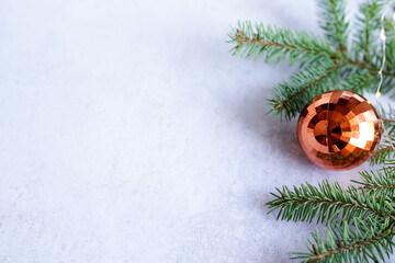 christmas background - decorations and fir branch on grey table, greeting card with copy space