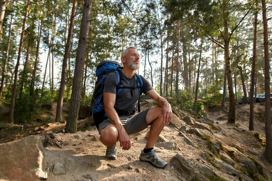 Smiling middle aged caucasian man with large backpack