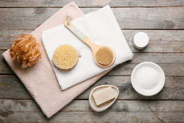 Composition with different massage brushes on wooden background