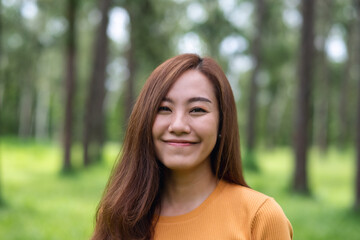 Portrait image of a beautiful young asian woman standing in the park