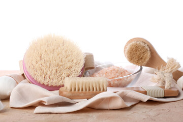Fototapeta na wymiar Different massage brushes and bath supplies on white background
