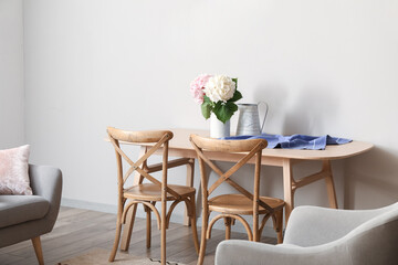 Vase with hydrangea flowers on table in room