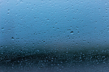 Raindrops on the glass of the car 