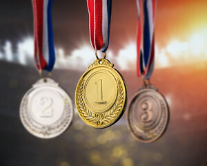 real Gold, silver and bronze medals hanging on red ribbons isolated on white background.