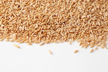 Background of peeled oat grains on white