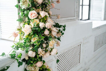 Decoration of the wall with artificial flowers peonies