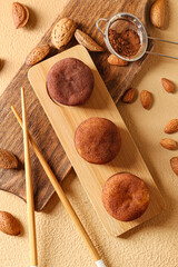 Tasty cacao mochi with nuts on color background