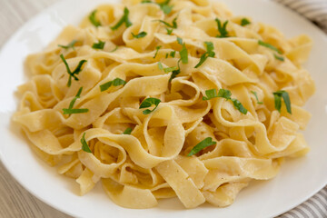 Homemade One Pot Garlic Parmesan Pasta with Parsley, side view. Close-up.