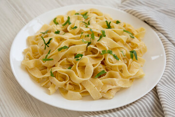 Homemade One Pot Garlic Parmesan Pasta with Parsley, side view. Close-up.