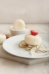 Plate with tasty coconut mochi on grunge background