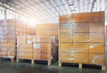 Stacked of Package Boxes Wrapped Plastic Flim on Pallets in The Storage Warehouse.  Storhouse. Shipping Warehouse Logistics.	