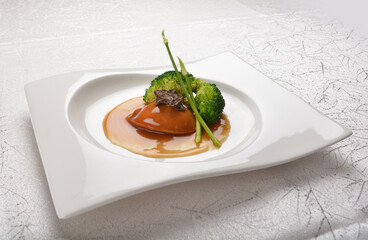 braised single whole big abalone seafood with vegetable and black truffle , ginseng in chef oyster sauce asian premium halal menu