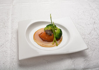 braised single whole big abalone seafood with vegetable and black truffle , ginseng in chef oyster sauce asian premium halal menu