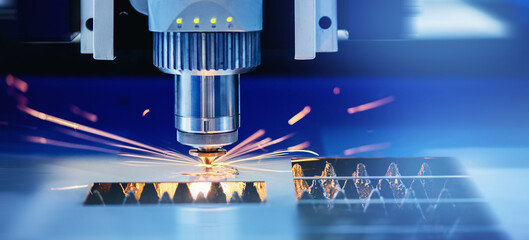Blue color Laser CNC cut of metal with light spark, technology modern industrial banner