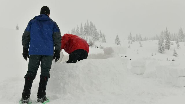 Snow igloo building in the high winter mountains