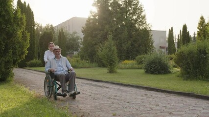 Happy smile of a man in wheelchair, park road