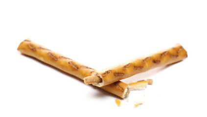 Cracker pretzel stick filled with peanuts broken in half isolated on white background